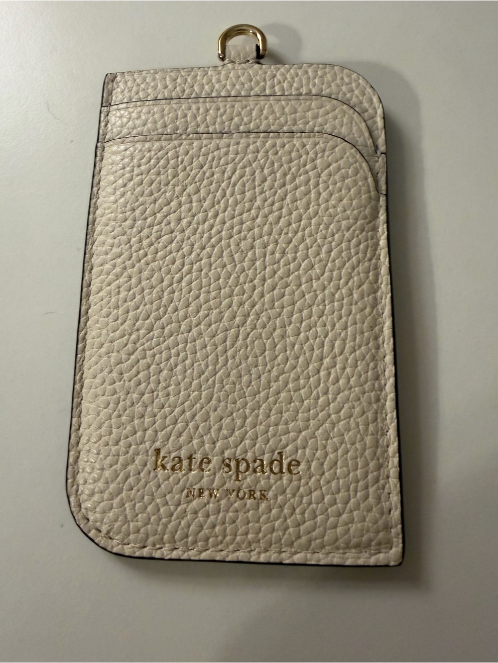 kate spade cream pebble leather card sleeve with gold logo